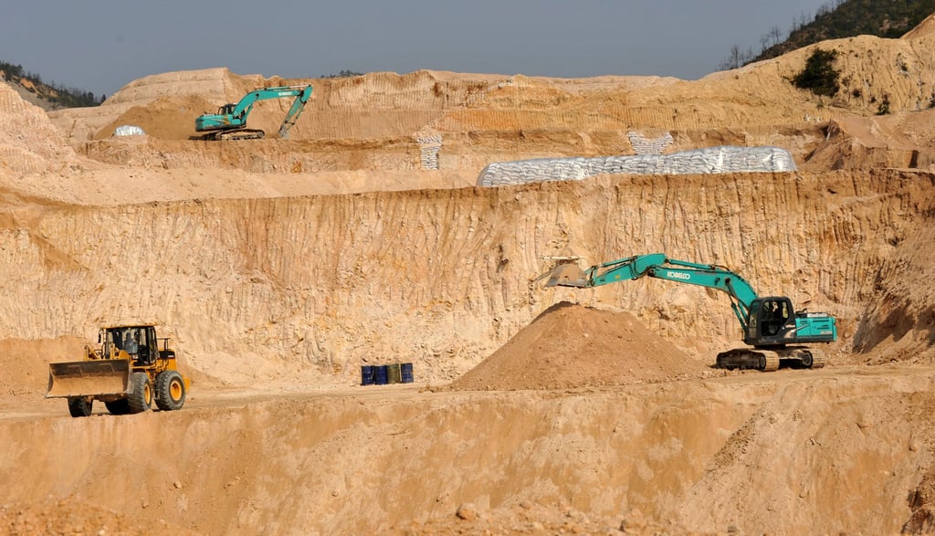 Workers use machinery to dig at a rare earth mine in Ganxian county in central China’s Jiangxi province. Photo: AP Workers use machinery to dig at a rare earth mine in Ganxian county in central China’s Jiangxi province. Photo: AP