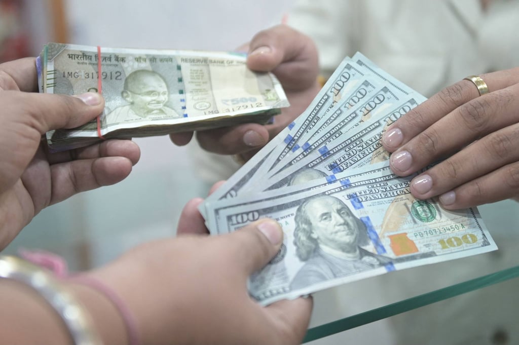 People exchange US dollar and Indian rupee banknotes at a foreign exchange office in Amritsar, India. India’s currency has shed around 5 per cent of its value in recent months. Photo: AFP