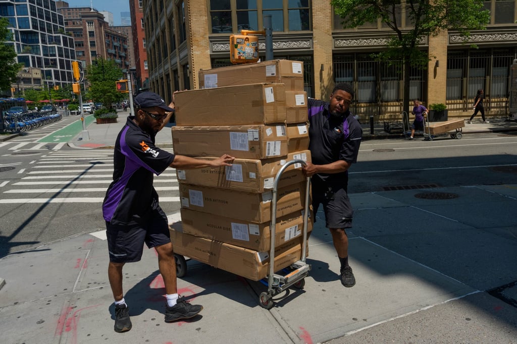 Workers move packages on Tuesday in New York. Photo: AP