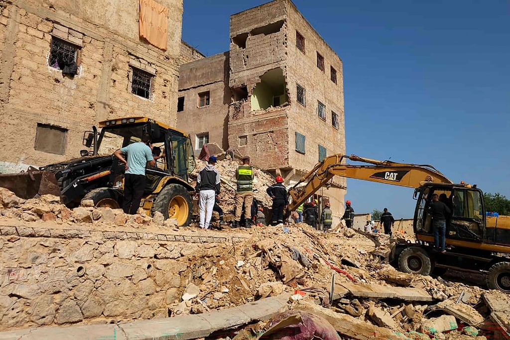 Rescuers and residents dig through the rubble on Thursday. Photo: AFP
