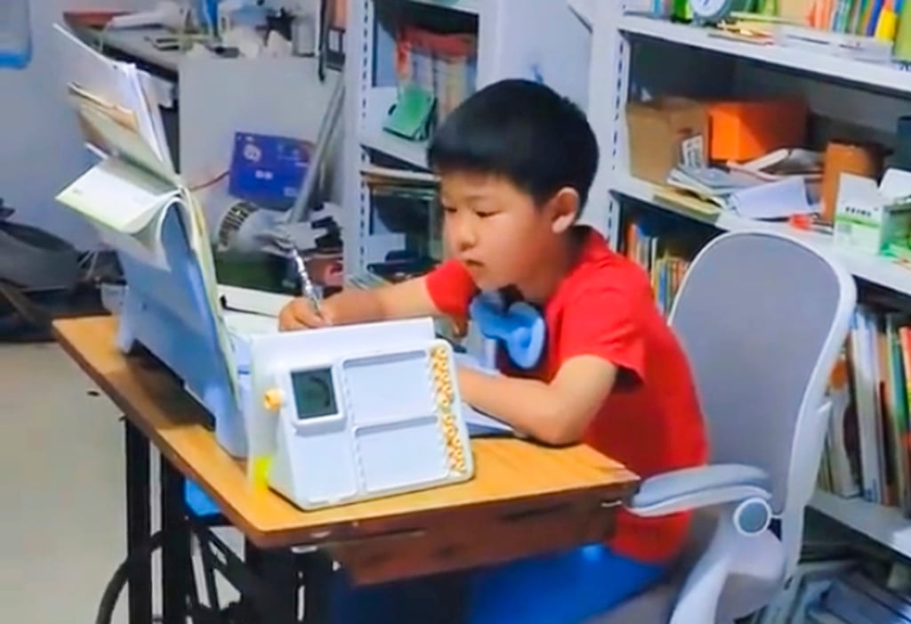 The youngster, above, does his homework as he simultaneously pedals the sewing machine. Photo: Weibo