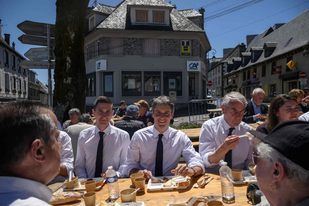 General Secretary of French centrist party Renaissance Gabriel Attal (middle) has lunch with members of his team and supporters after announcing his candidacy for the 2027 presidential elections during a visit to the village of Mur-de-Barrez in southwestern France on Friday. Photo: AFP