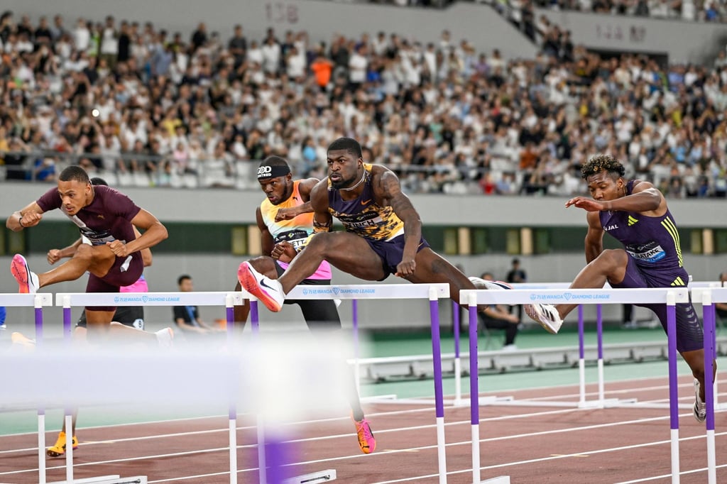 Cordell Tinch (centre), here competing in Zhejiang Province in May, is the 110m world champion. Photo: AFP