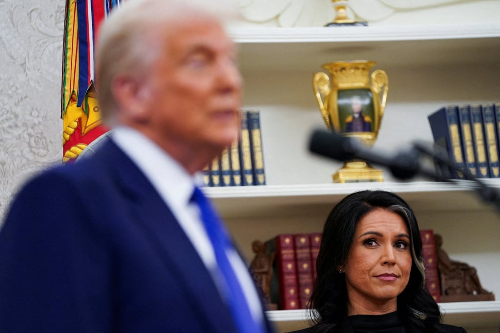 Tulsi Gabbard looks at US President Donald Trump during her swearing-in ceremony as director of national intelligence at the White House in February 2025. Photo: Reuters Tulsi Gabbard looks at US President Donald Trump during her swearing-in ceremony as director of national intelligence at the White House in February 2025. Photo: Reuters
