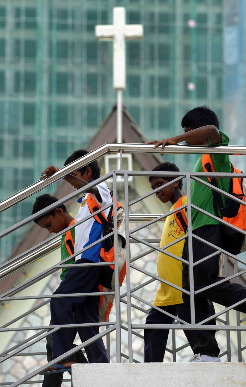 Schoolboys walk down from a bridge in front of a church in Kuala Lumpur. Photo: AFP Schoolboys walk down from a bridge in front of a church in Kuala Lumpur. Photo: AFP