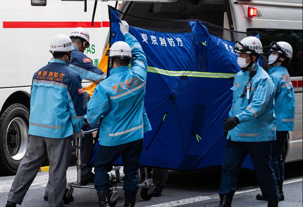 A person is taken on a stretcher to an ambulance at the Ginza Six Shopping Centre in Tokyo on Monday. Photo: AFP