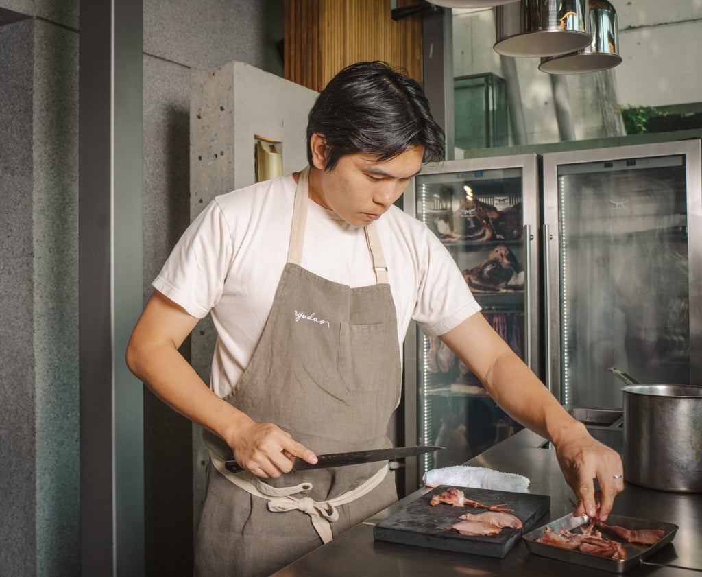 Yang prepares a quail dish. Photo: Alexander Mak Yang prepares a quail dish. Photo: Alexander Mak