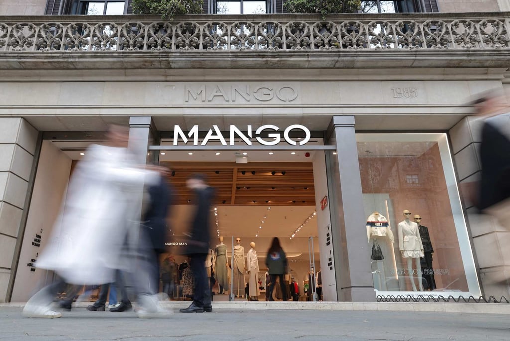 Pedestrians walk by the entrance of a Mango shop on Passeig de Gracia street in Barcelona. Photo: AFP Pedestrians walk by the entrance of a Mango shop on Passeig de Gracia street in Barcelona. Photo: AFP