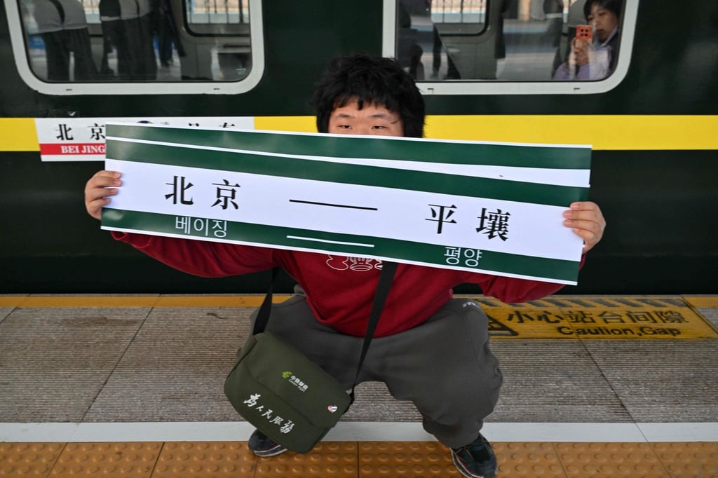 A man holds a banner reading “Beijing-Pyongyang” in front of a train bound for Pyongyang at Beijing Railway Station on March 12. Photo: AFP A man holds a banner reading “Beijing-Pyongyang” in front of a train bound for Pyongyang at Beijing Railway Station on March 12. Photo: AFP