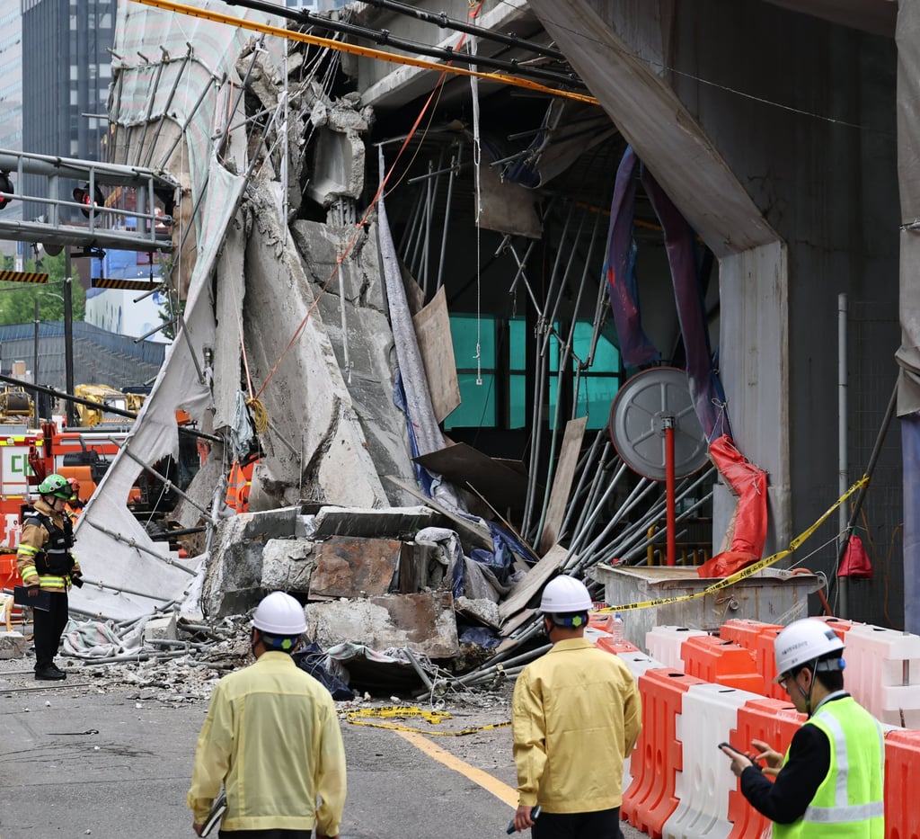 South Korean rescue teams inspect the scene where an overpass collapsed while it was being dismantled in Seoul on Tuesday. Photo: Yonhap/AP