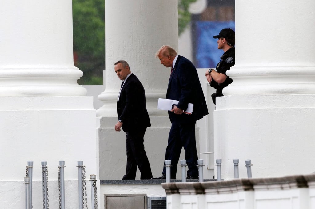 US President Donald Trump (centre) leaves the White House for Walter Reed National Military Medical Centre on Tuesday. Photo: EPA