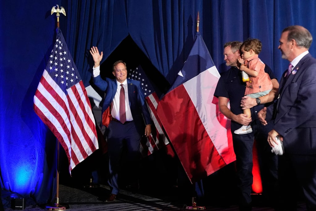Ken Paxton takes the stage after securing victory. Photo: AP
