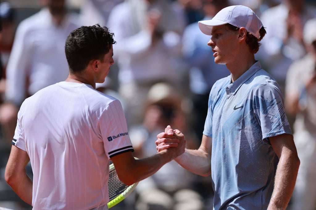 Juan Manuel Cerundolo (left) and Jannik Sinner shake hands after their match. Photo: Reuters