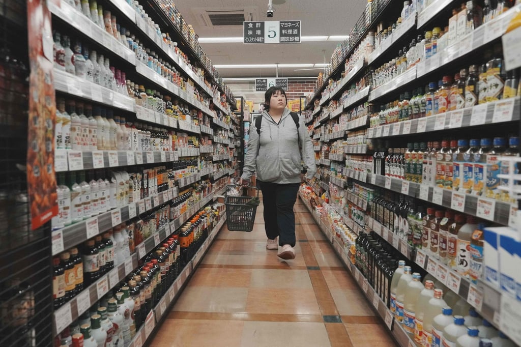 A customer shops in a supermarket in Tokyo on May 22. Photo: AFP A customer shops in a supermarket in Tokyo on May 22. Photo: AFP