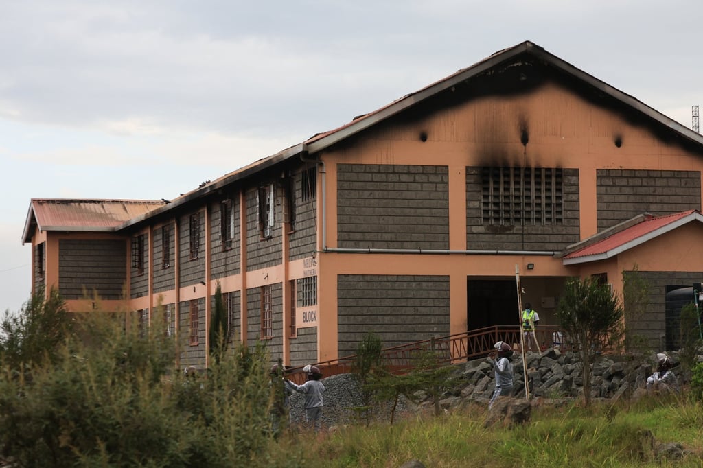 People stand near the dormitory building at Utumishi Girls’ Academy after part of it caught fire overnight in Nakuru, northwest of Nairobi, Kenya on Thursday. photo: EPA People stand near the dormitory building at Utumishi Girls’ Academy after part of it caught fire overnight in Nakuru, northwest of Nairobi, Kenya on Thursday. photo: EPA