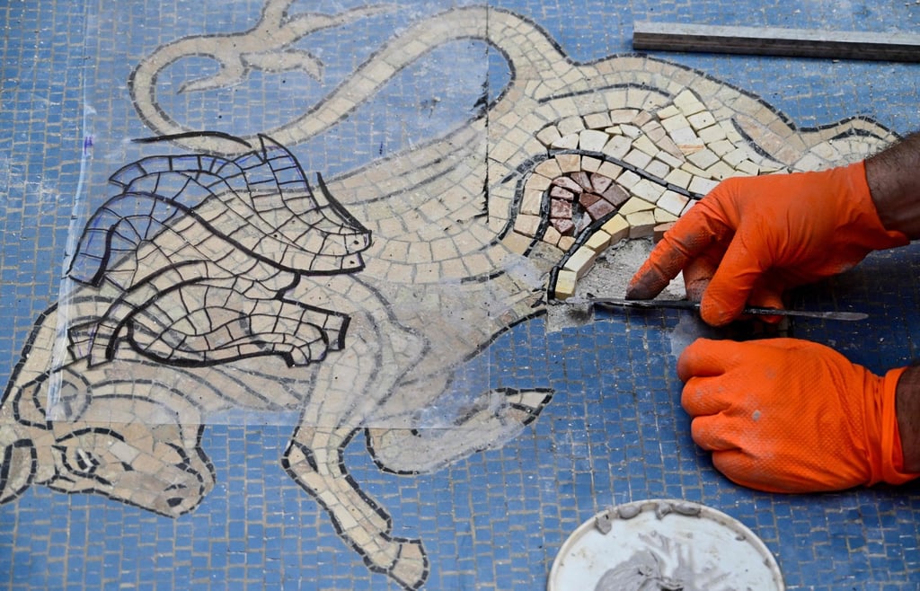 The beige bull mosaic is part of the flooring in the 19th century shopping arcade near Milan’s famous Duomo cathedral. Photo: AFP The beige bull mosaic is part of the flooring in the 19th century shopping arcade near Milan’s famous Duomo cathedral. Photo: AFP