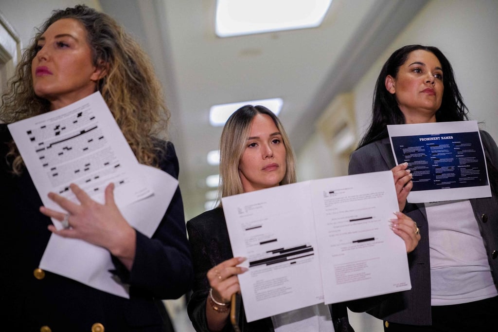 Epstein survivors (from left) Lara Blume McGee, Andrea Sterling and Sharlene Rochard hold up redacted documents related to the investigation outside a House Oversight Committee closed-door interview with former US Attorney General Pam Bondi on Friday. Photo: AFP