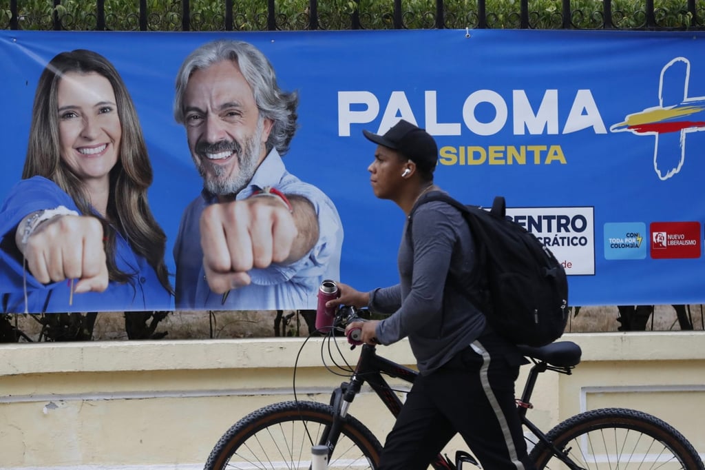 A person walks past a campaign poster for Colombian presidential candidate Paloma Valencia in Barranquilla, Colombia, on Saturday. Photo: EPA