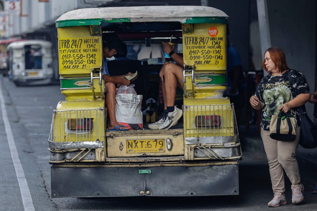 A passenger approaches a jeepney minibus in Marikina City last month. Transport costs have surged in the Philippines amid the US-Israel war on Iran. Photo: EPA A passenger approaches a jeepney minibus in Marikina City last month. Transport costs have surged in the Philippines amid the US-Israel war on Iran. Photo: EPA