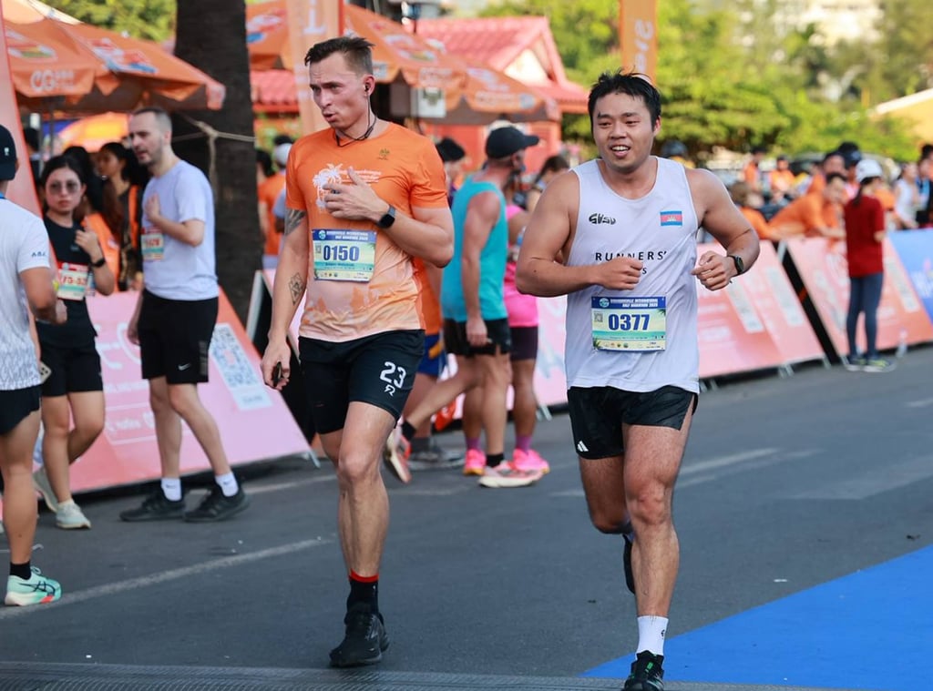 Johnson Lo (right), at the International Sihanoukville half marathon, says running alongside the Mekong River in Phnom Penh is a favourite route of his. Photo: Johnson Lo Johnson Lo (right), at the International Sihanoukville half marathon, says running alongside the Mekong River in Phnom Penh is a favourite route of his. Photo: Johnson Lo