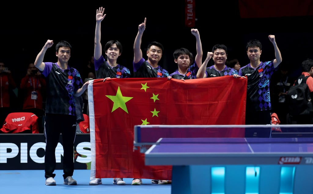China’s men (from left) Xiang Peng, Wang Chuqin, coach Wang Hao, Lin Shidong, Liang Jingkun and Zhou Qihao celebrate winning the World Team Table Tennis Championship. Photo: Xinhua