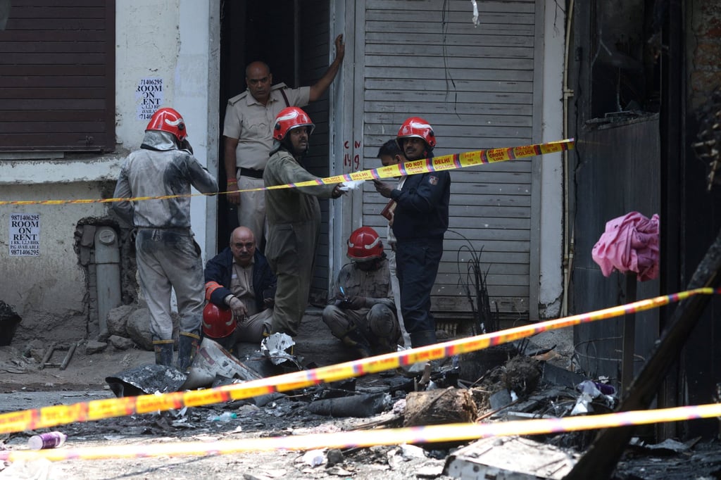 Firefighters work at the site of a fire, which broke out in the morning at Flourish Stay, a bed-and-breakfast in a congested neighbourhood in the south of the New Delhi on Wednesday. Photo: Reuters