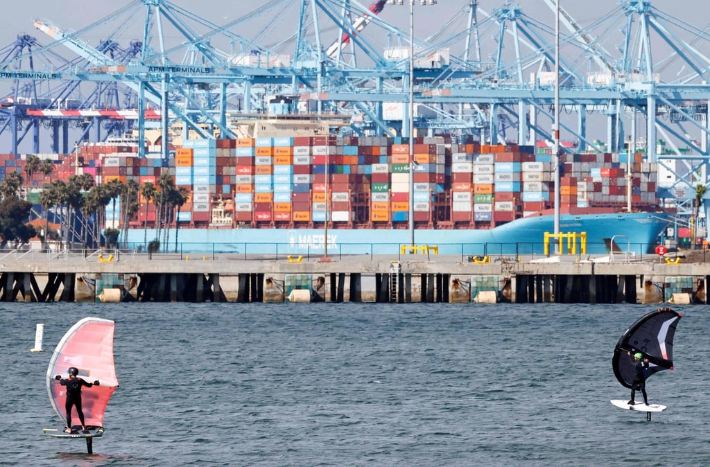 People ride wing foils near a container ship at the Port of Los Angeles on Thursday. Photo: AFP