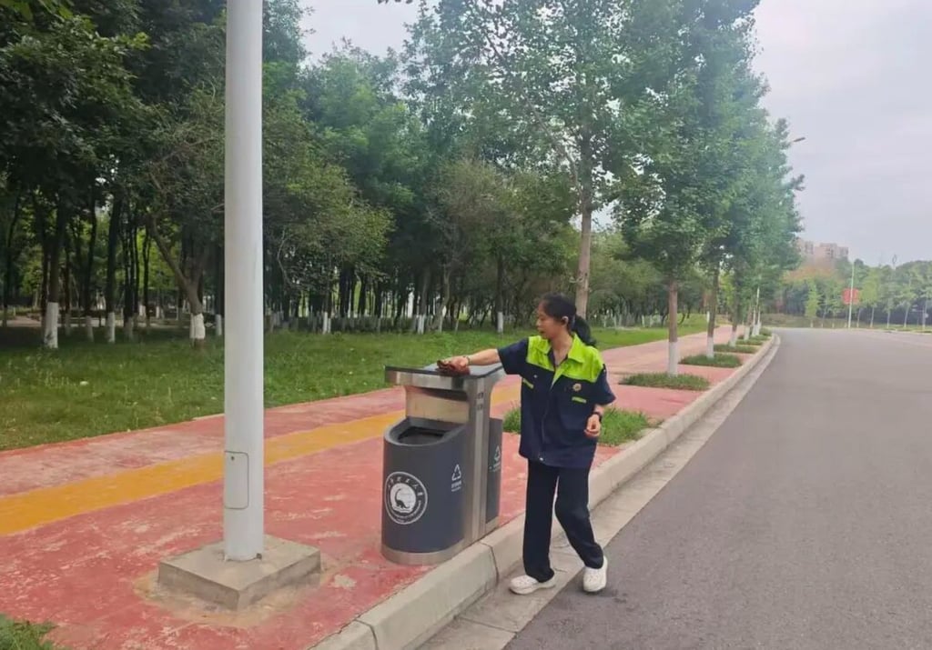 Li Jia, above, cleans a rubbish bin situated beside some trees. Photo: Baidu Li Jia, above, cleans a rubbish bin situated beside some trees. Photo: Baidu