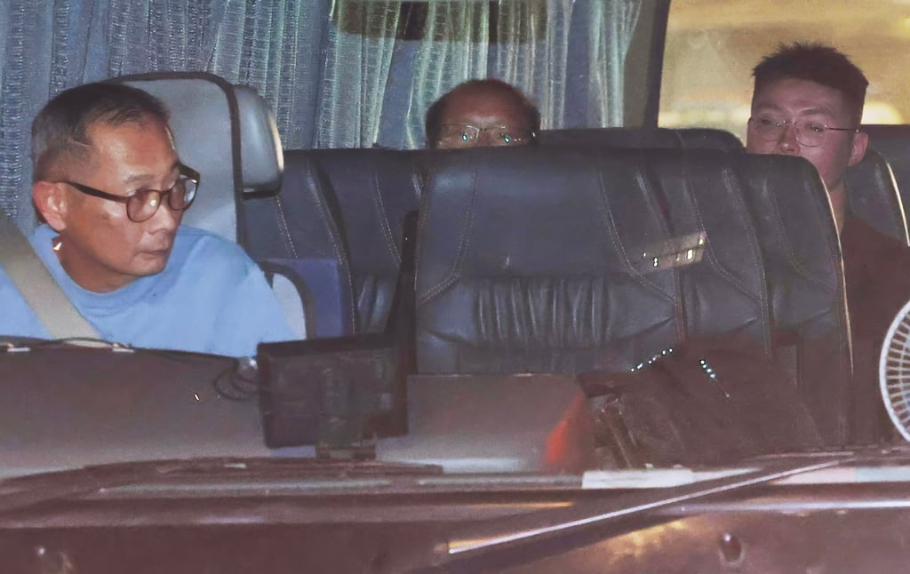 Tsang Wai-bong (Centre) and Kwan Pui-sin (not pictured) were escorted to the Immigration Department to assist with the investigation. Photo: Edmond So