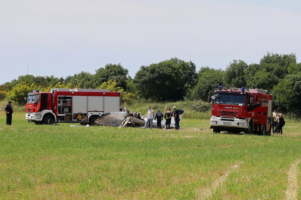 Firefighters and police inspect the site where a small plane crashed in Croatia on Thursday. Photo: AP