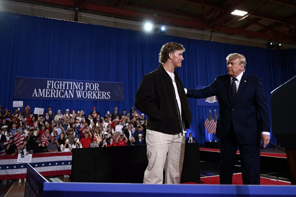 US President Donald Trump welcomed by New York Giants quarterback Jaxson Dart at Rockland Community College in New York, in May. Photo: AFP/Getty Images/TNS