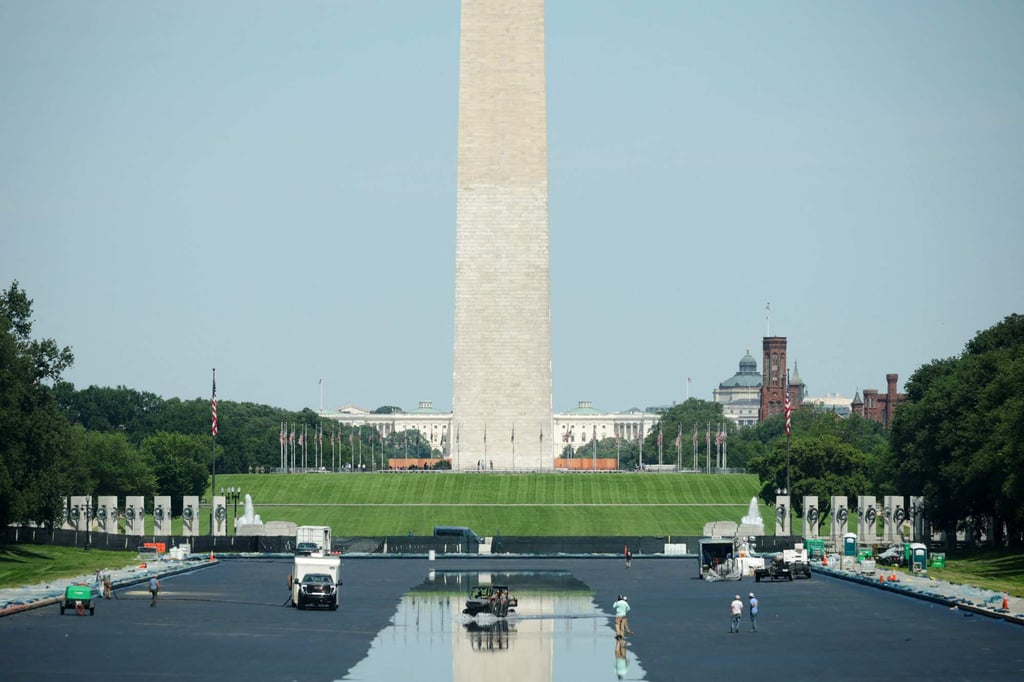 Workers drive through the Lincoln Memorial Reflecting Pool as it fills with water on Thursday. Photo: AFP
