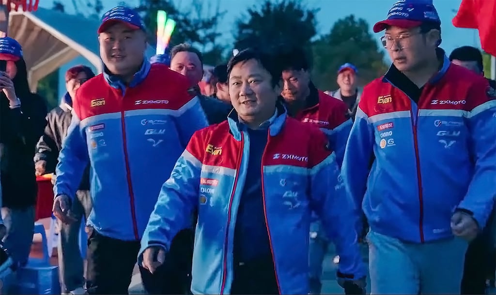 Zhang Xue, centre, strides out with members of his team at an event. Photo: Instagram/ZXMOTO Zhang Xue, centre, strides out with members of his team at an event. Photo: Instagram/ZXMOTO
