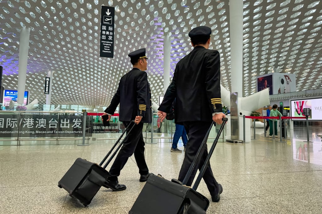 Two airline pilots walk through the departure hall of Shenzhen Bao’an International Airport on April 13, 2025. Photo: Getty Images