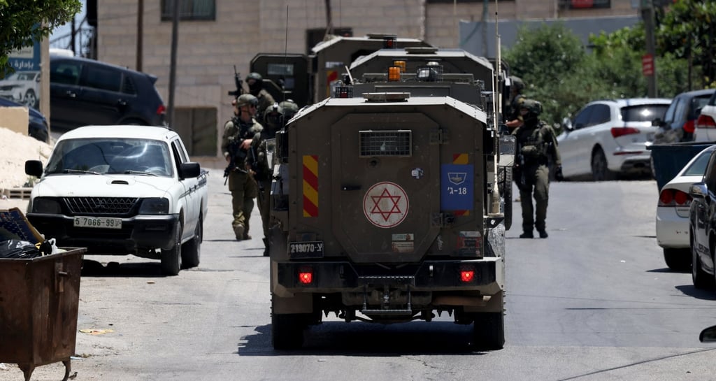 Israeli soldiers take up positions during a raid in the West Bank city of Nablus on Monday. Photo: EPA