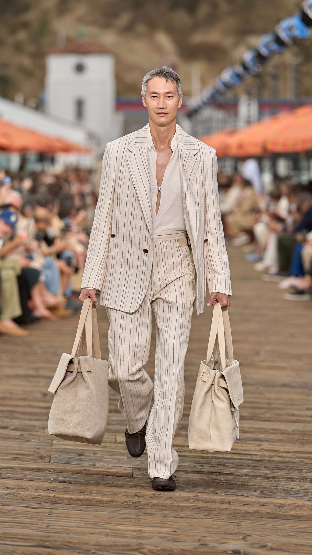 The show opened with a pinstriped look in a loose cut. Photo: Handout The show opened with a pinstriped look in a loose cut. Photo: Handout