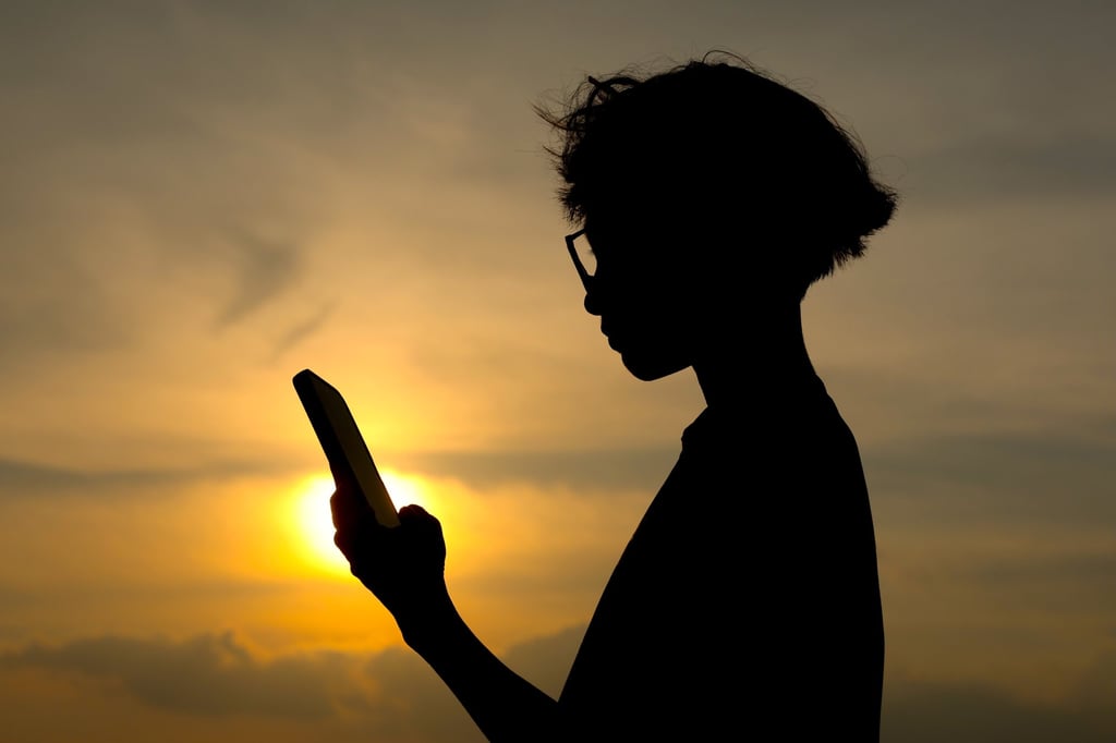 A child looks at his mobile phone. Photo: EPA/FAZRY ISMAIL