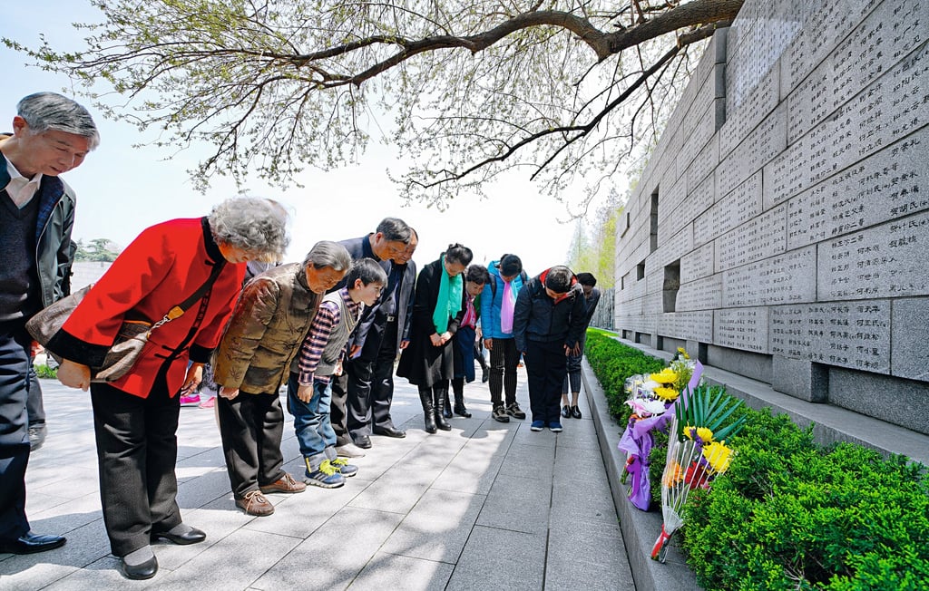Survivors of the Nanking massacre and their relatives pay their respects at the Memorial Hall of the Victims in the Nanking Massacre by Japanese Invaders in Nanjing in China’s eastern Jiangsu province. Photo: Xinhua