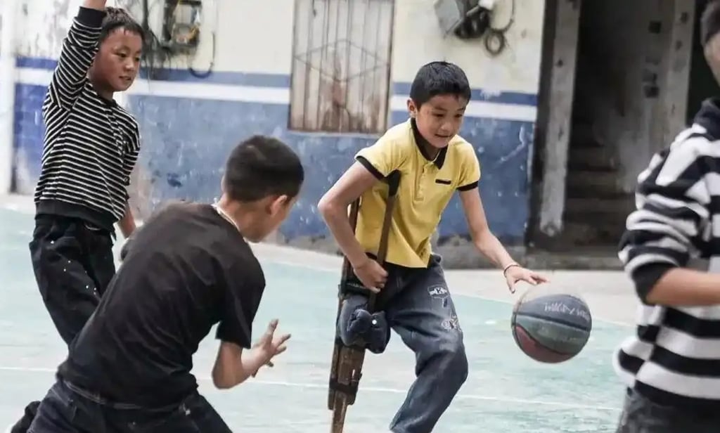 Apei, above, weaves some magic on the basketball court using the crutch his father made. Photo: Handout Apei, above, weaves some magic on the basketball court using the crutch his father made. Photo: Handout