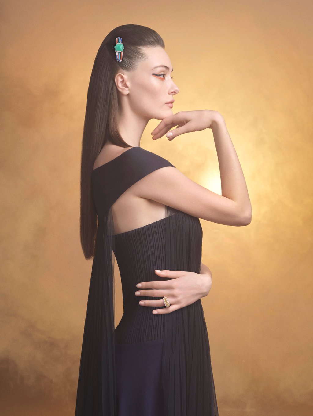 A clip in gold, emeralds, rubies, sapphires, coral, chrysoprase, turquoise, onyx and diamonds adorns the model’s hair. Photo: Handout