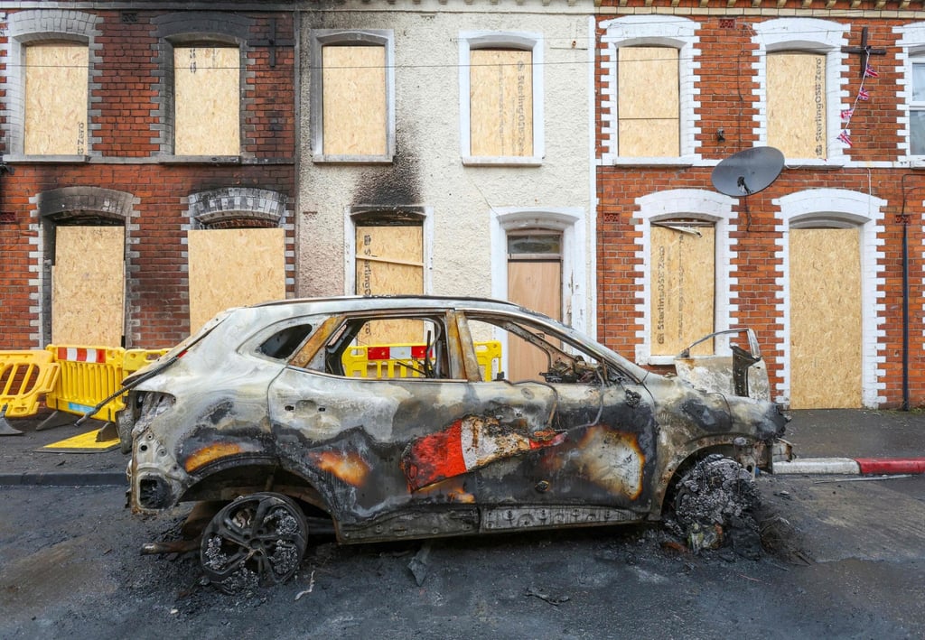 A wrecked car is pictured outside boarded-up houses in Belfast, Northern Ireland, on Thursday after two consecutive nights of violence. Photo: AFP A wrecked car is pictured outside boarded-up houses in Belfast, Northern Ireland, on Thursday after two consecutive nights of violence. Photo: AFP