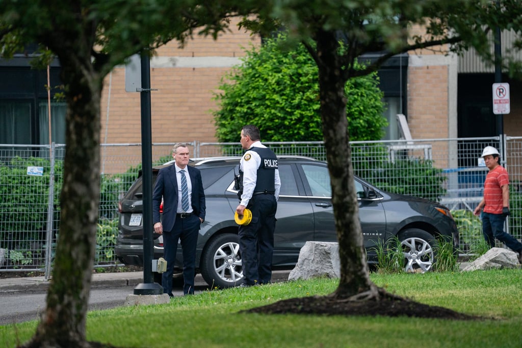 Investigators work the scene where a police officer was shot in Toronto on Thursday. Photo: The Canadian Press via AP Investigators work the scene where a police officer was shot in Toronto on Thursday. Photo: The Canadian Press via AP
