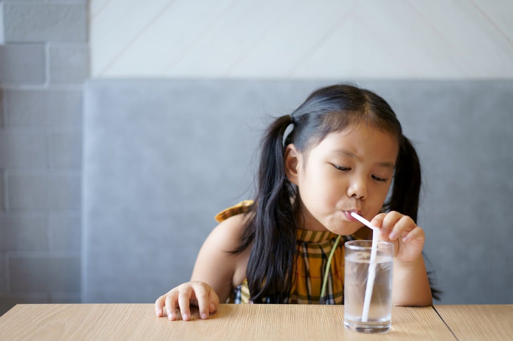 A little girl in China uses a straw to drink an iced beverage. Photo: Shutterstock A little girl in China uses a straw to drink an iced beverage. Photo: Shutterstock