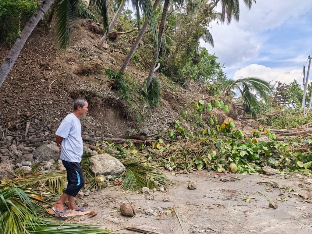 A man stands on a blocked road after a major landslide triggered by an earthquake, in Sarangani Province, the Philippines, on Thursday. Photo: Xinhua A man stands on a blocked road after a major landslide triggered by an earthquake, in Sarangani Province, the Philippines, on Thursday. Photo: Xinhua