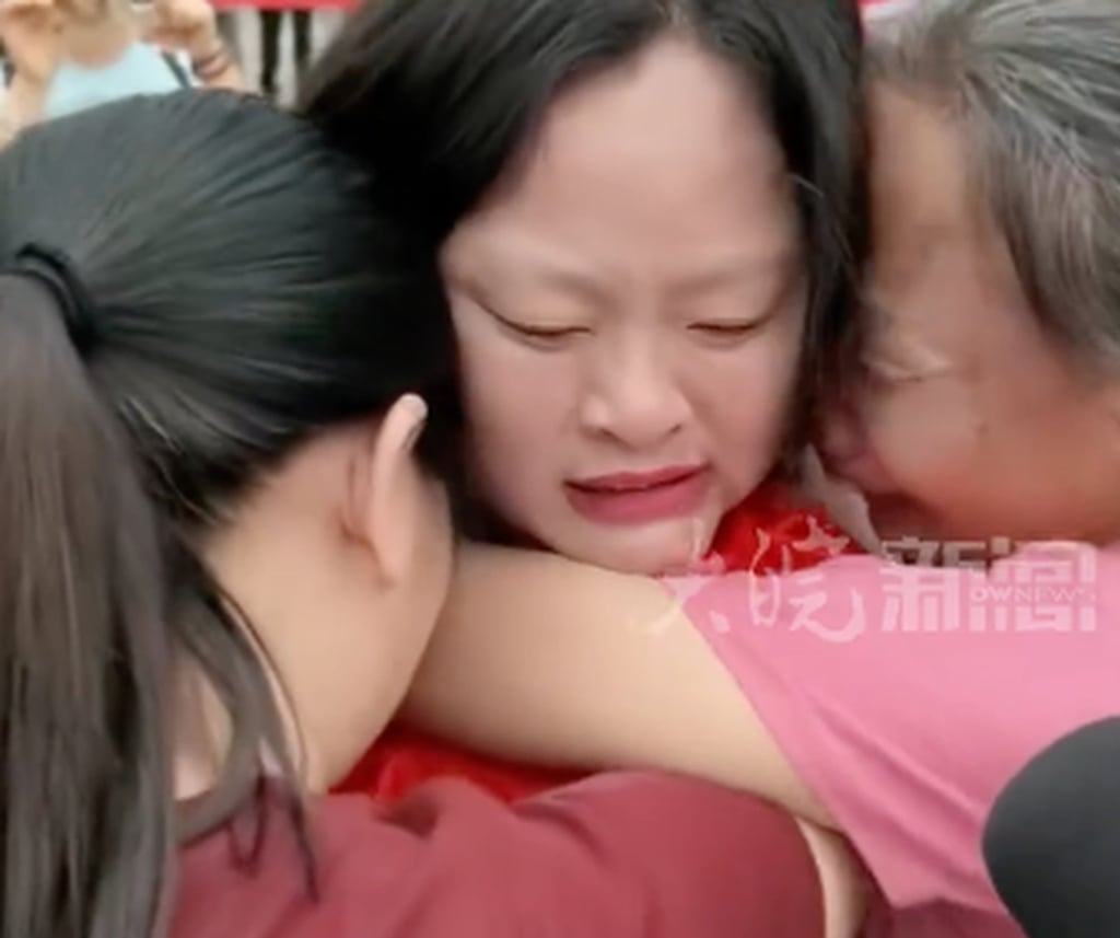 Liu, centre, is embraced by two members of her birth family. Photo: Douyin Liu, centre, is embraced by two members of her birth family. Photo: Douyin