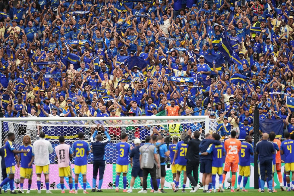 Curacao fans applaud their players after the side’s Group E game against Germany. Photo: AP Curacao fans applaud their players after the side’s Group E game against Germany. Photo: AP