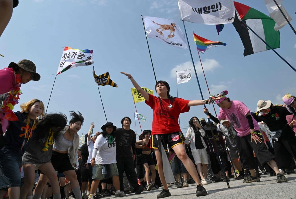 Revellers dance during a performance by South Korean indie rock band Peach Truck Hijackers on Sunday. Photo: AFP Revellers dance during a performance by South Korean indie rock band Peach Truck Hijackers on Sunday. Photo: AFP