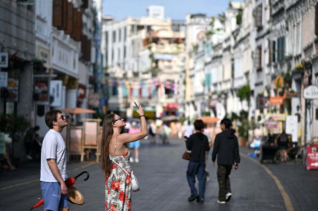 Foreign tourists visit Qilou Old Street in Haikou, in China’s southern island province of Hainan on May 9. Photo: Xinhua