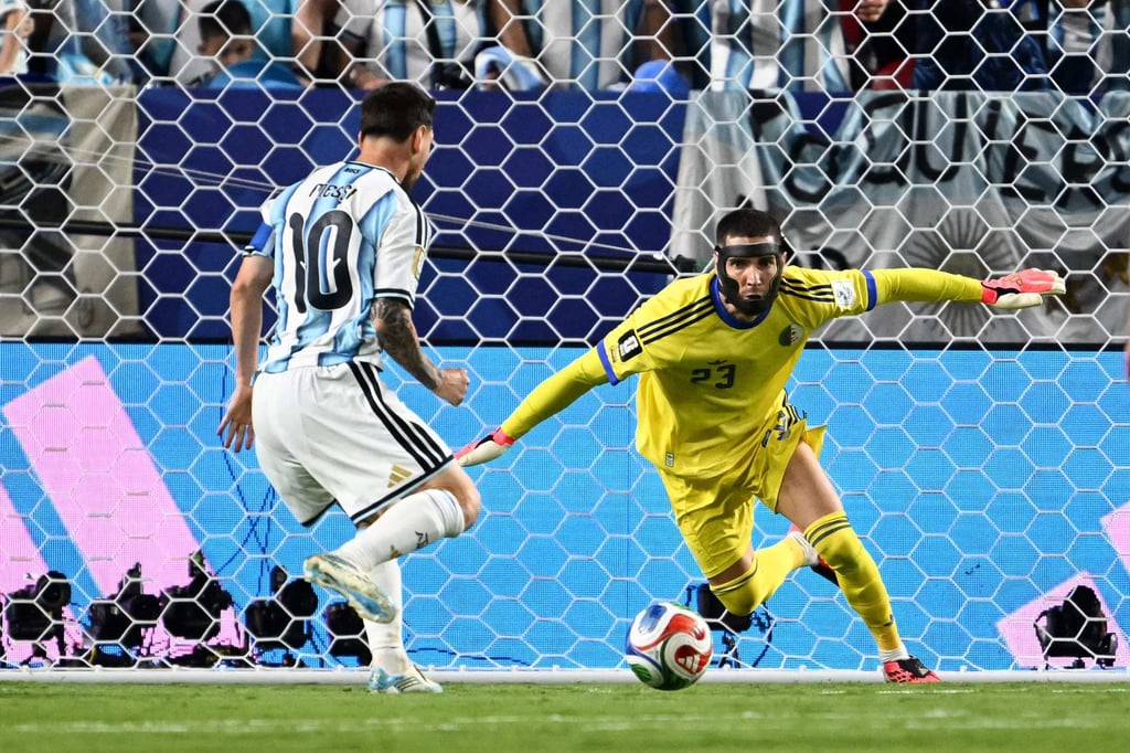 Lionel Messi places the ball past Algeria’s goalkeeper Luca Zidane to put his side 2-0 up. Photo: AFP Lionel Messi places the ball past Algeria’s goalkeeper Luca Zidane to put his side 2-0 up. Photo: AFP
