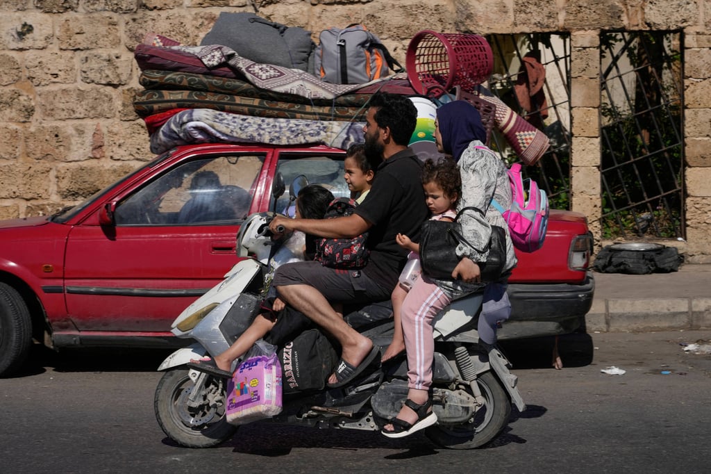 Displaced families flee Israeli strikes on a highway in the southern port city of Sidon, Lebanon, on Friday. Photo: AP Displaced families flee Israeli strikes on a highway in the southern port city of Sidon, Lebanon, on Friday. Photo: AP